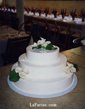 A wedding cake decorated with calla lilies
